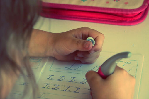 The child writes homework