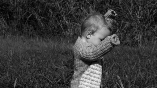 Toddler walking on the meadow