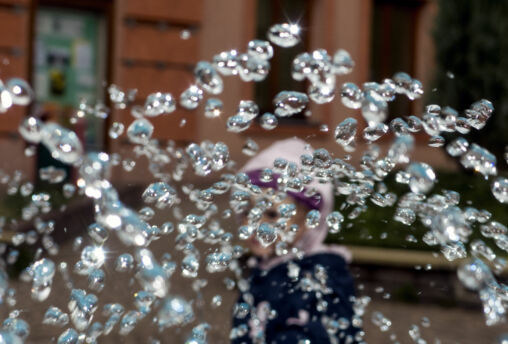 Child behind the water drops