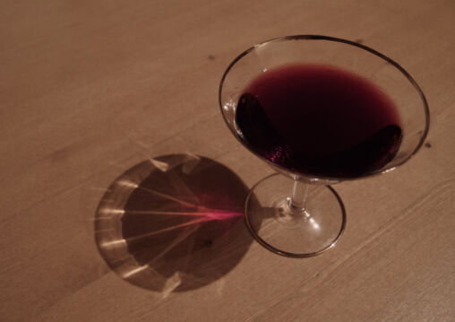 Glass of red wine on a wooden table