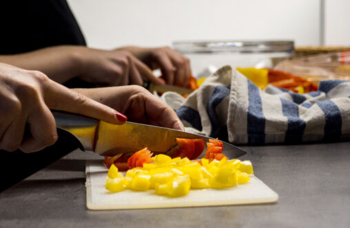 Hands cutting vegetables