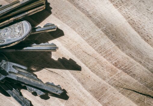 Bunch of keys on the wooden table.