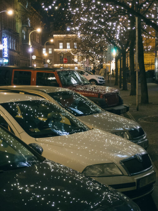 Christmas Lights Reflected On Car Hoods