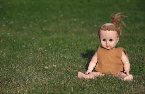 Vintage doll on the grass