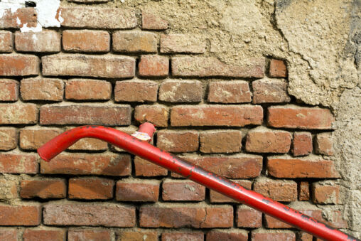 Old Brick Wall With Red Handrail