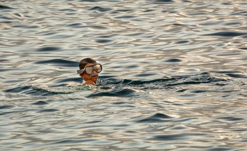 A Little Boy Diving in the Sea